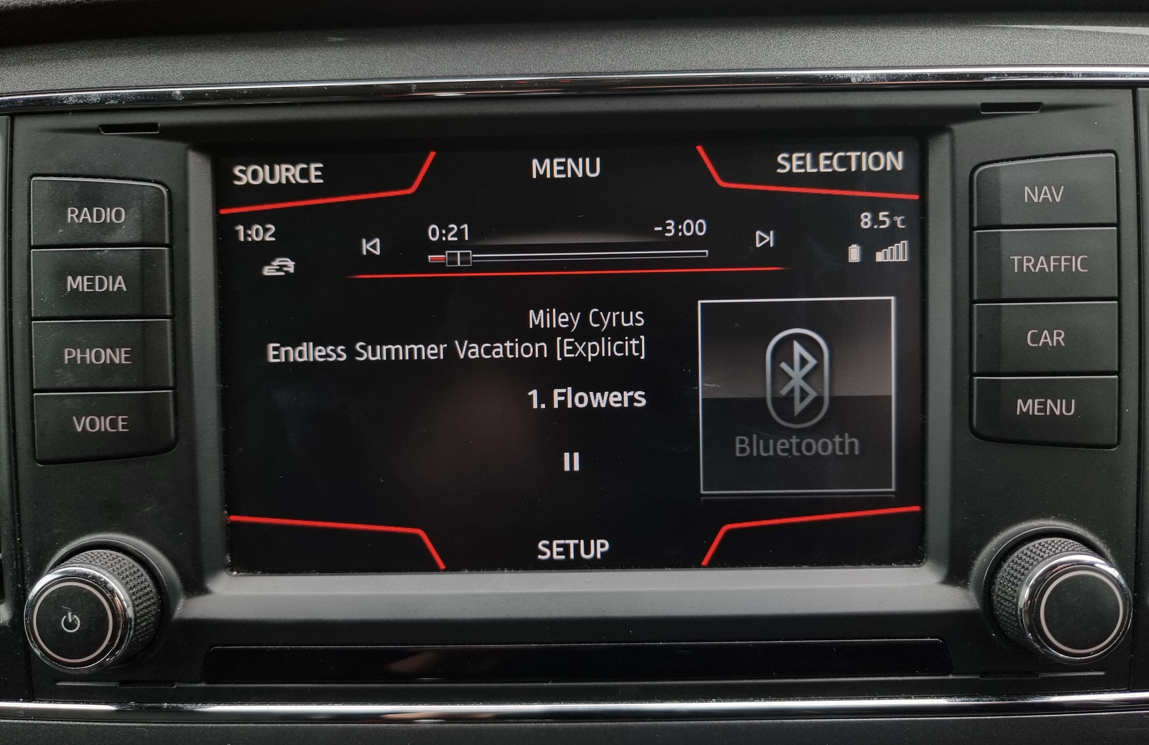 Image shows a black car stereo, which is playing Miley Cyrus - Flowers via Bluetooth connection/.