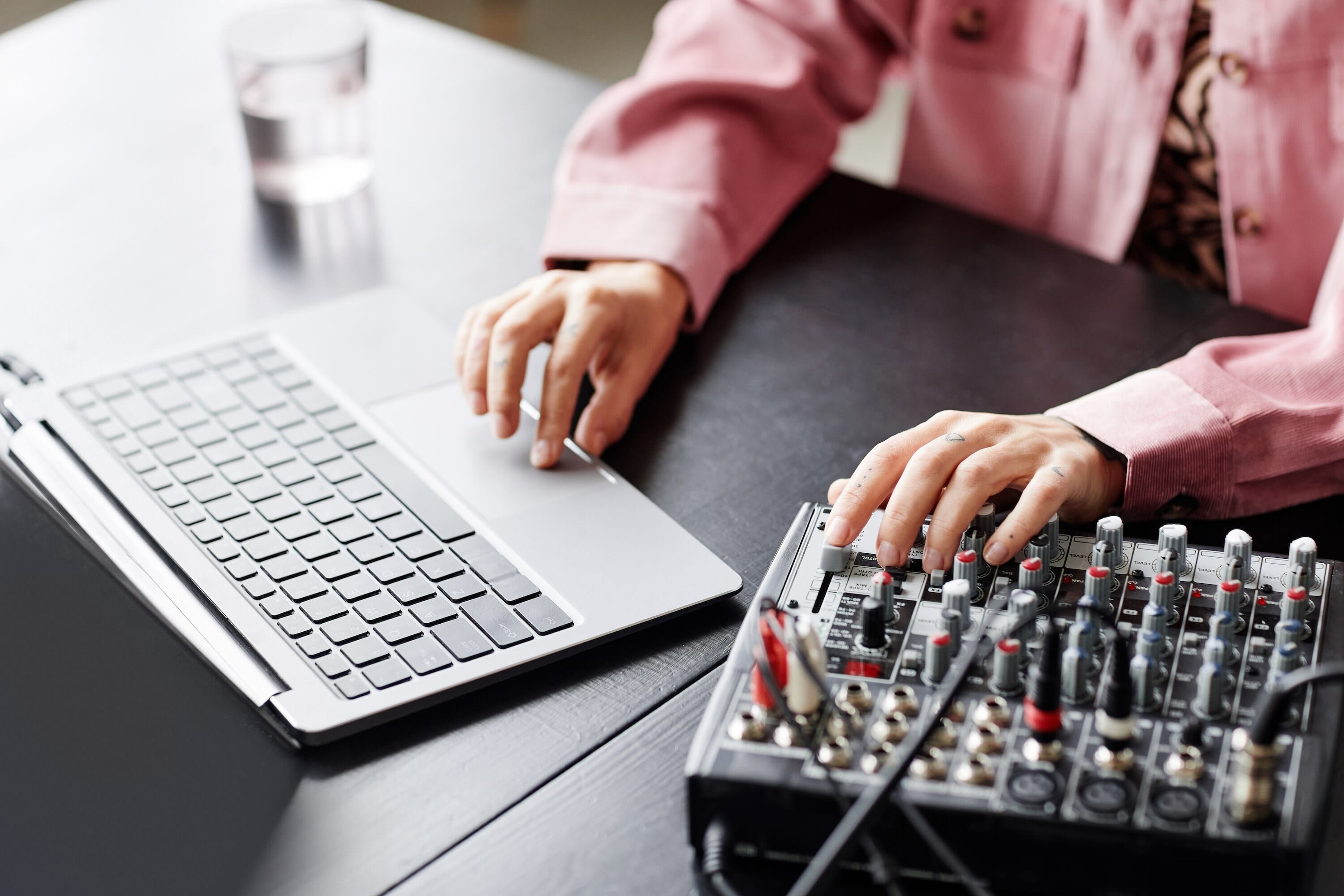 Female Using Laptop And Setting Up Radio Equipment