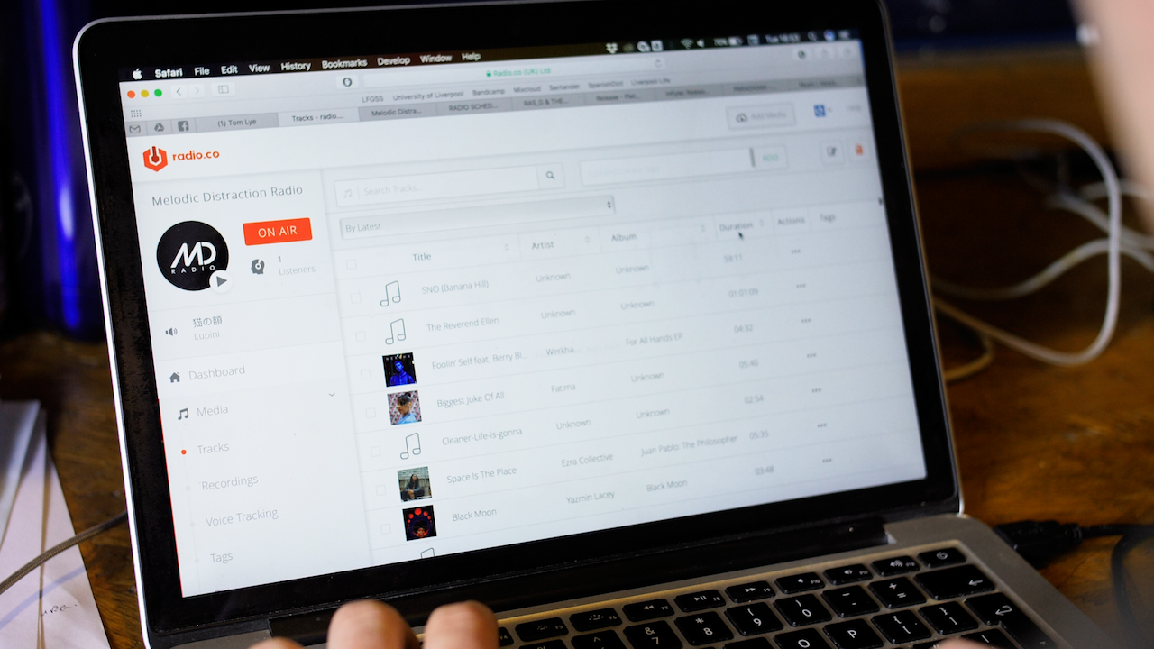 Image shows a laptop with Radio.co dashboard open on the screen.