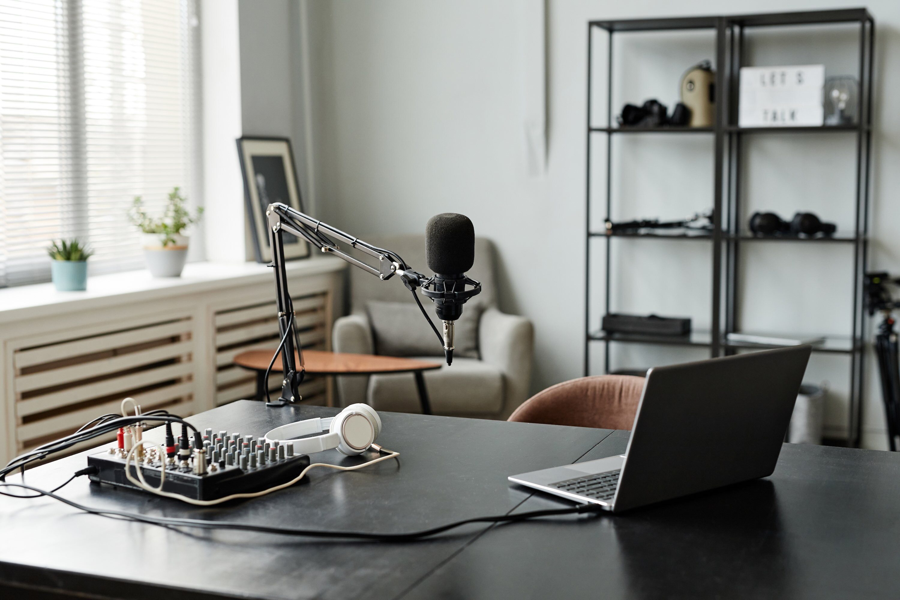 Microphone On Stand And Laptop On Desk