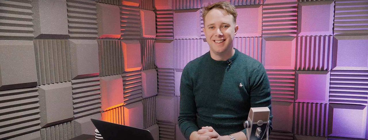 Image shows Radio.co CEO & founder, James Mulvany, sitting in a sound-proofed studio.