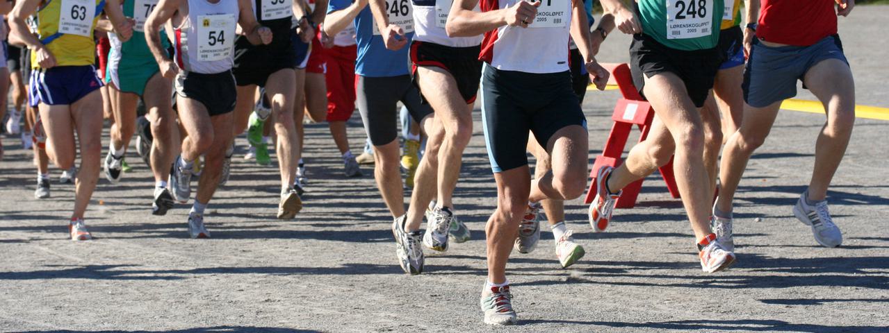Marathon runners running along a road.