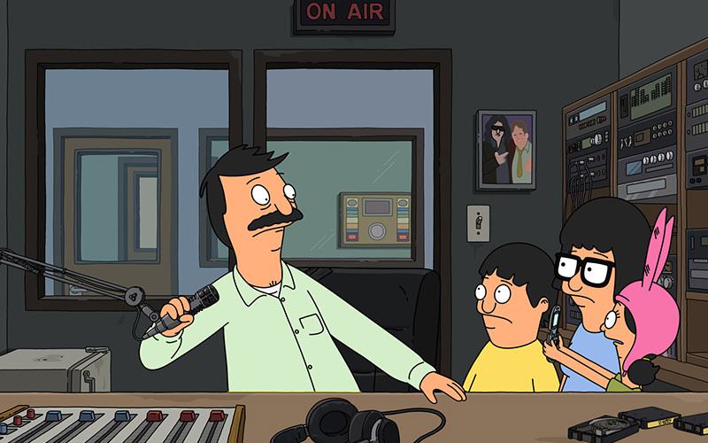 Image is a still from the TV Show Bob's Burgers, showing Bob, Jean , Tina and Louise in a radio studio.