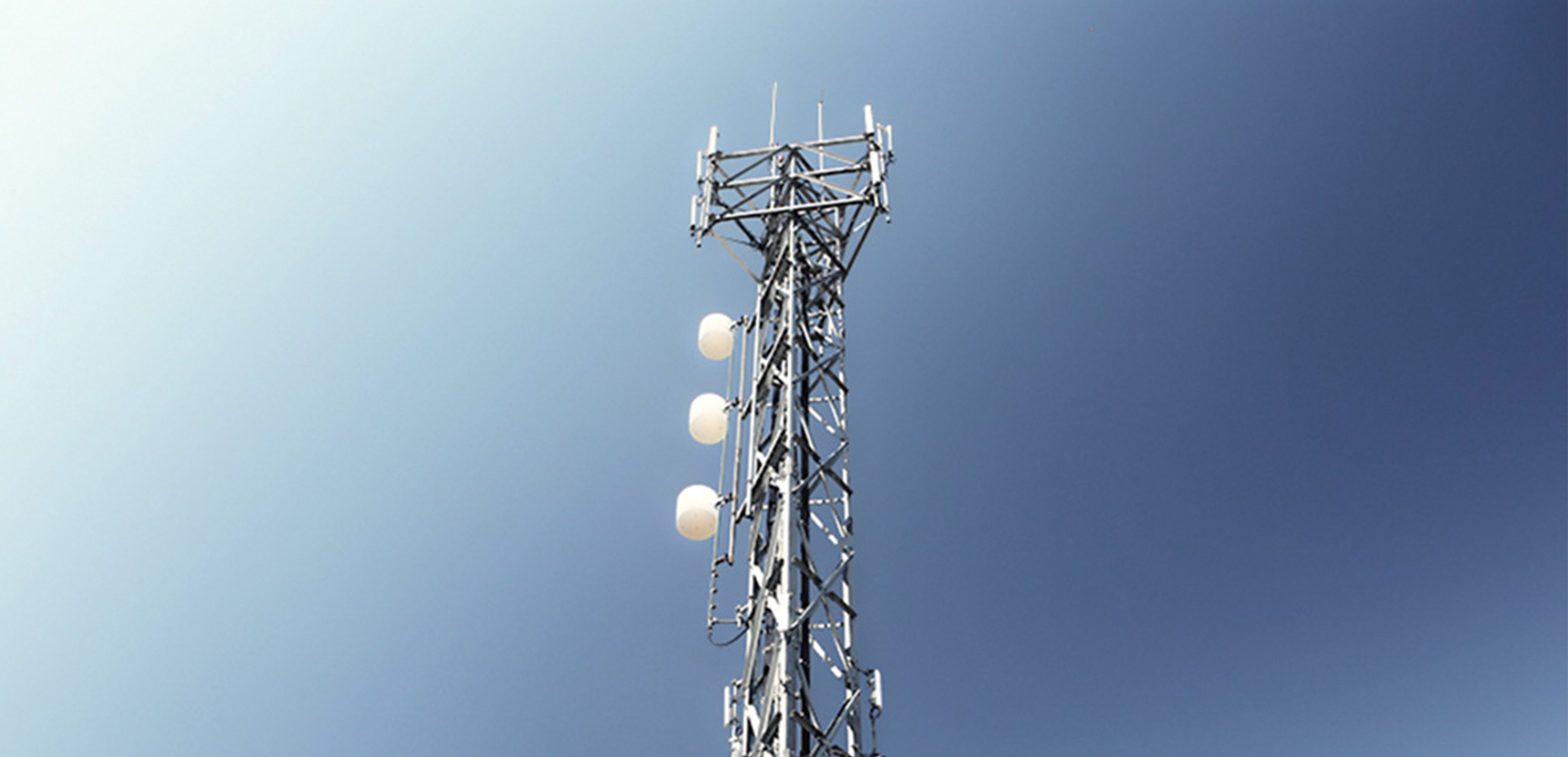 A radio transmitter against a blue sky.