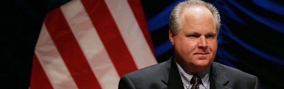Image shows a head and shoulders shot of Rush Limbaugh, with an American flag behind him.