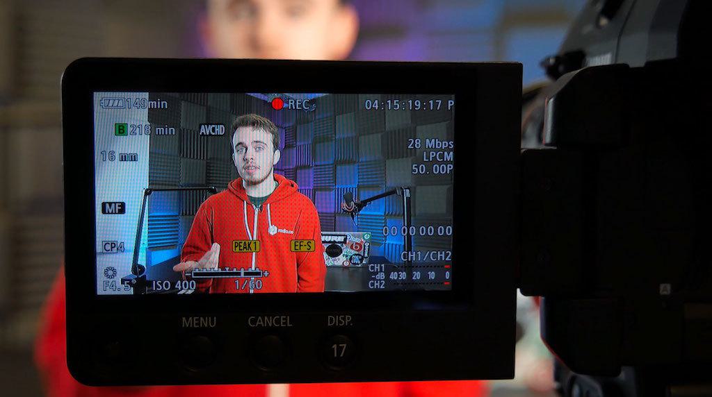 Image shows a camera screen, with a man presenting their livestream.