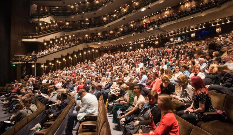 Image shows the audience at Barbican's performing arts theatre
