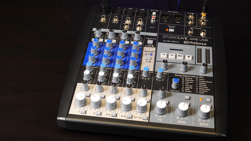 Image shows the PreSonus StudioLive AR8 USB Mixer on a black table.