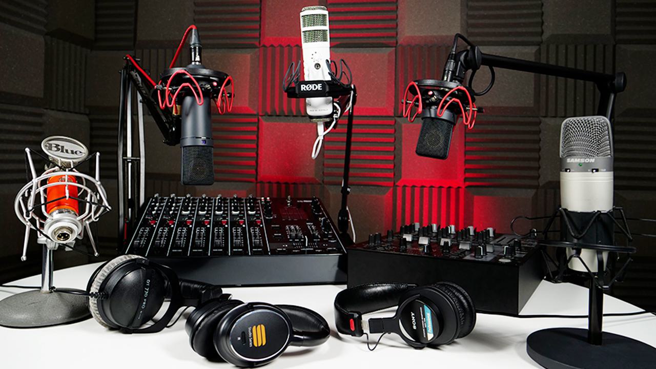 A screenshot of the Professional Audio Equipment Webinar video. It is a red background of a studio, and on the table are all of the pieces of equipment we recommend; microphones, Podcasters, mixing desks, everything