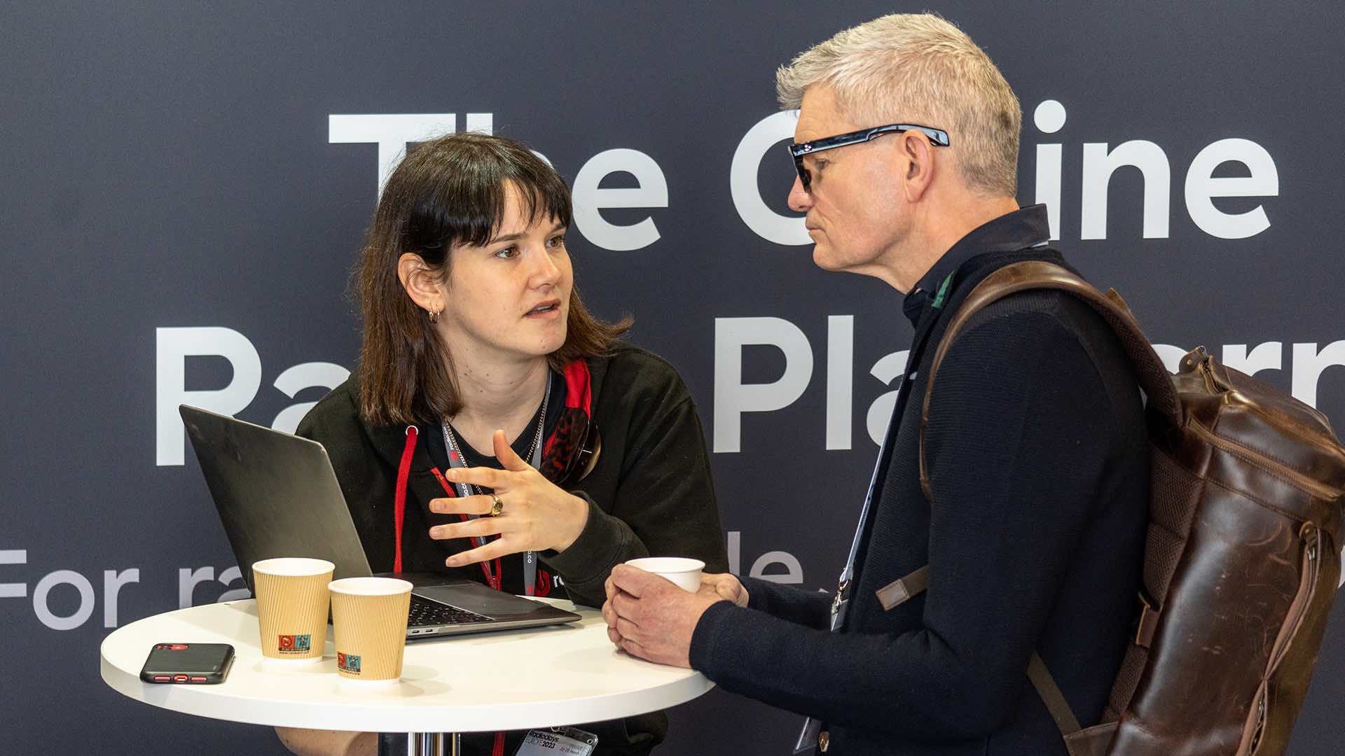 A Radio.co employee speaking to an attendee at Radiodays Europe 2023.