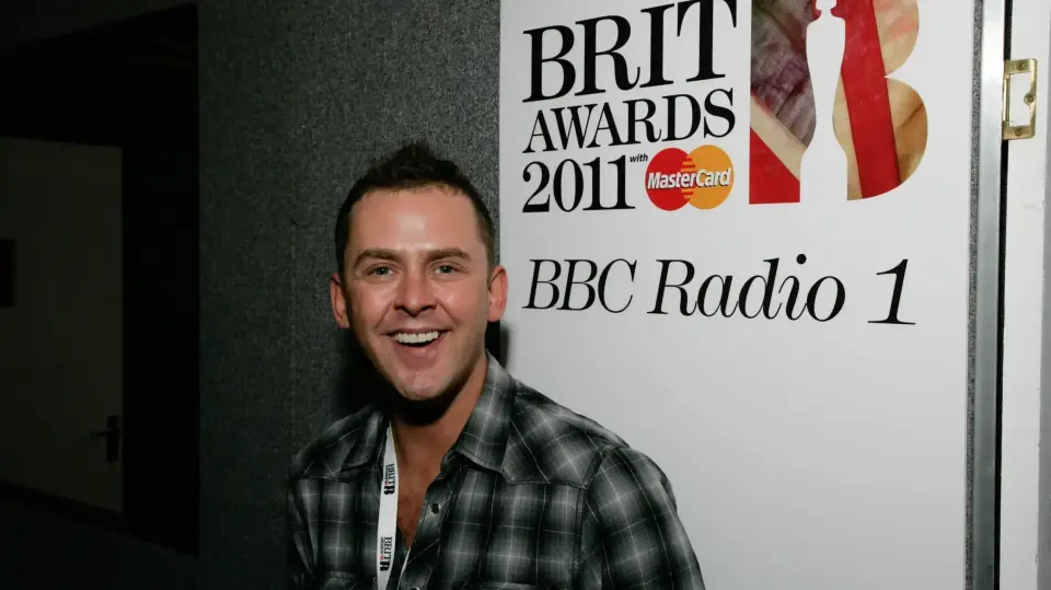 A photo of Scott Mills smiling and looking at the camera, taken at the 2011 Brit Awards.
